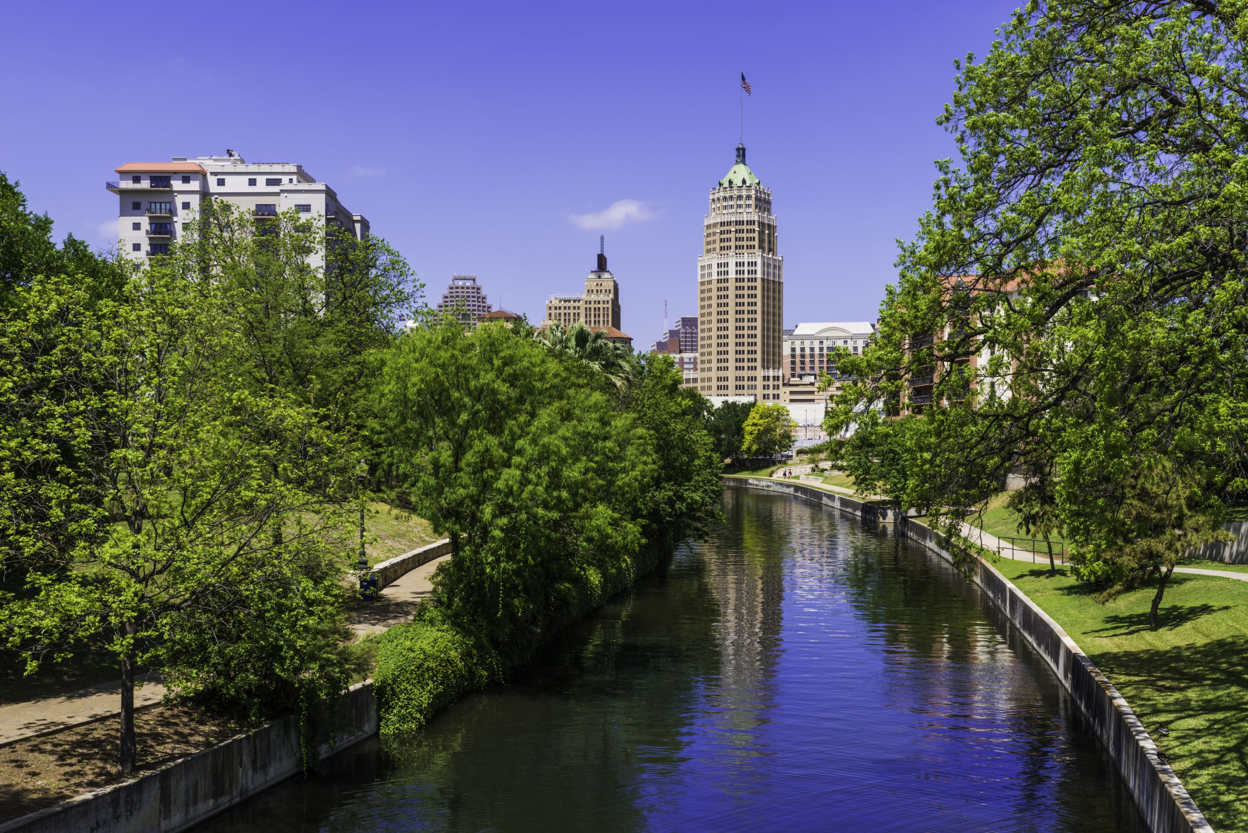 Riverwalk San Antonio Texas skyline, park walkway along scenic canal
